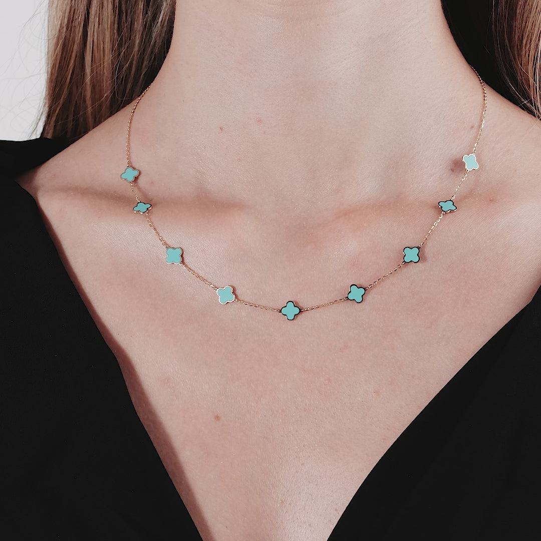14K yellow gold turquoise four leaf clover necklace worn on a model, showcasing its elegant design and craftsmanship.