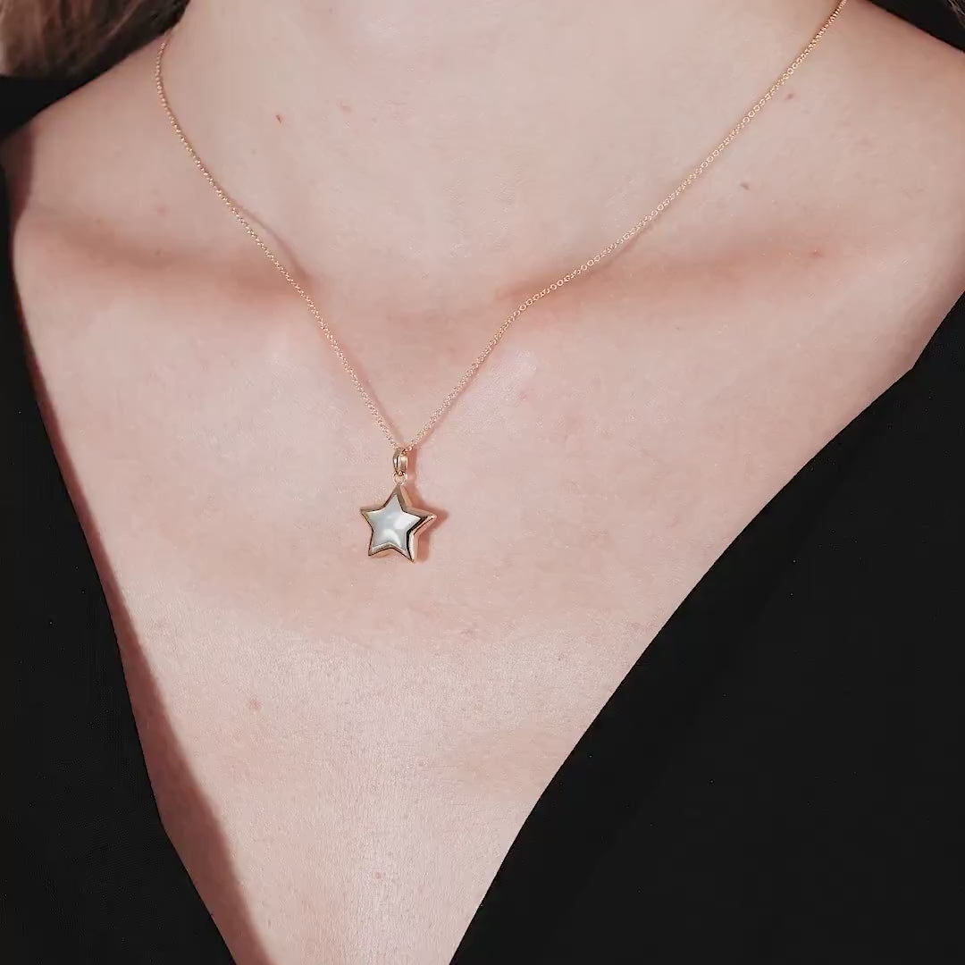 14K yellow gold necklace featuring a mother of pearl star pendant, elegantly worn on a model's neck.