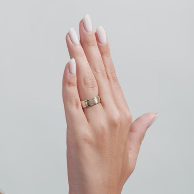 Hand displaying a 6mm 10K 14K 18K yellow gold men's wedding band with a satin finish.