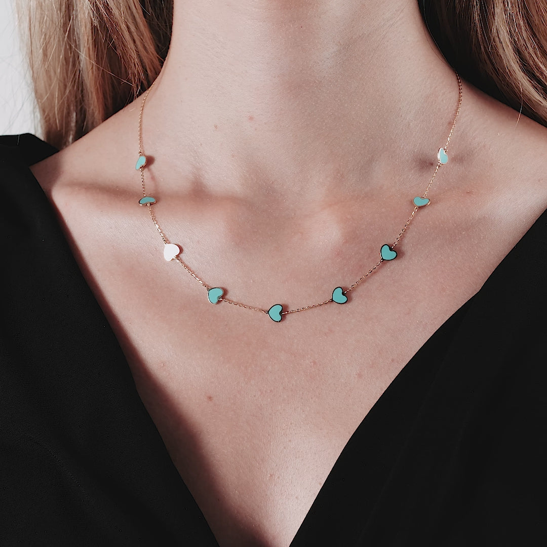 14K solid yellow gold turquoise heart necklace worn by a model, featuring a delicate design with lobster clasp.