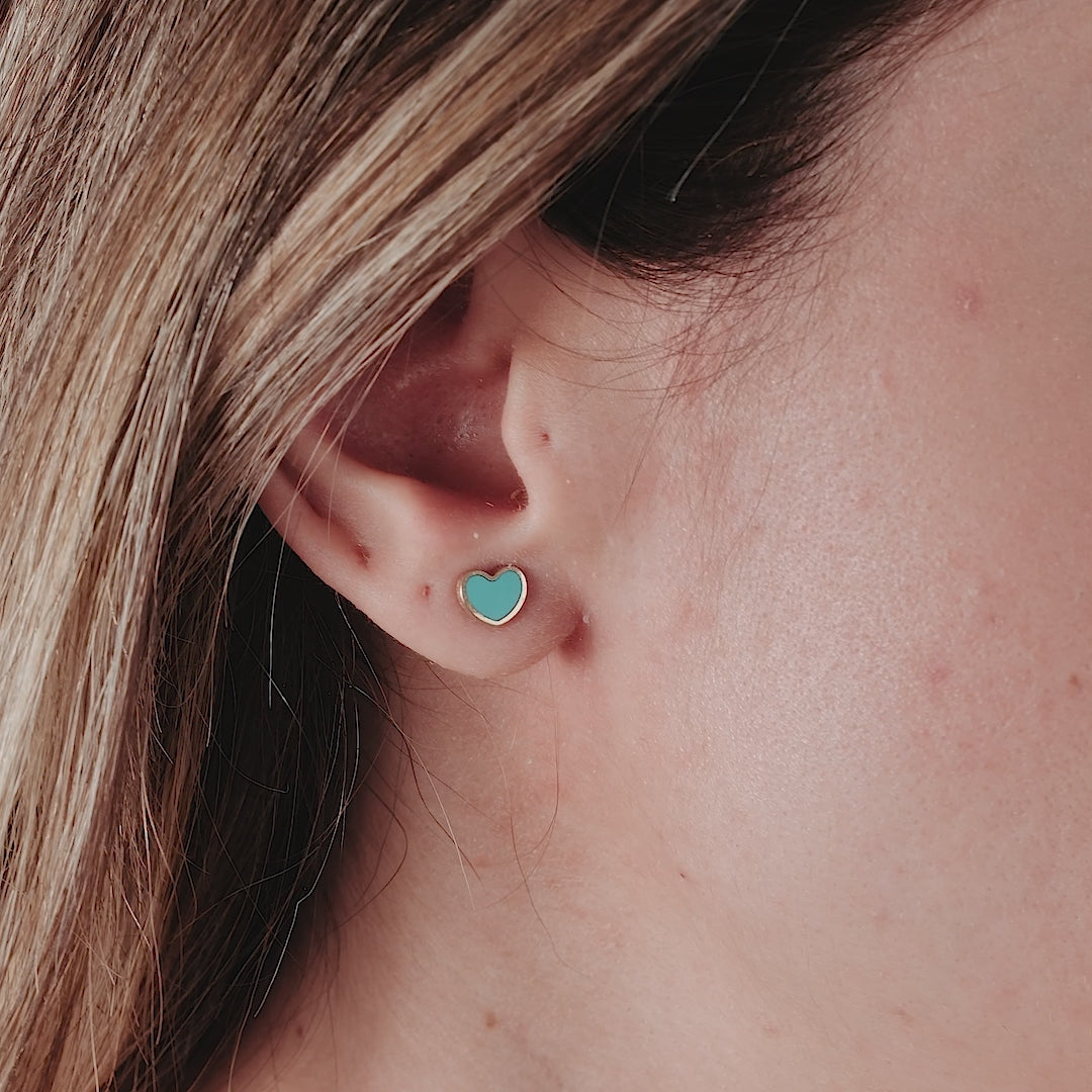 14K yellow gold turquoise heart stud earrings worn by a woman, showcasing minimalist design and everyday elegance.