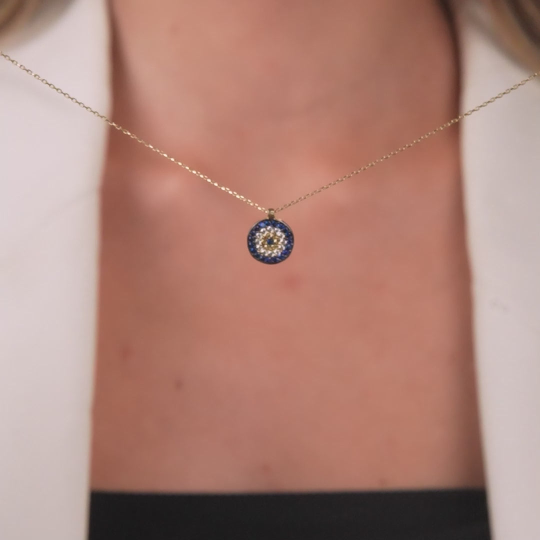 14K solid yellow gold minimalist evil eye necklace featuring a round pendant with blue and white cubic zirconia.