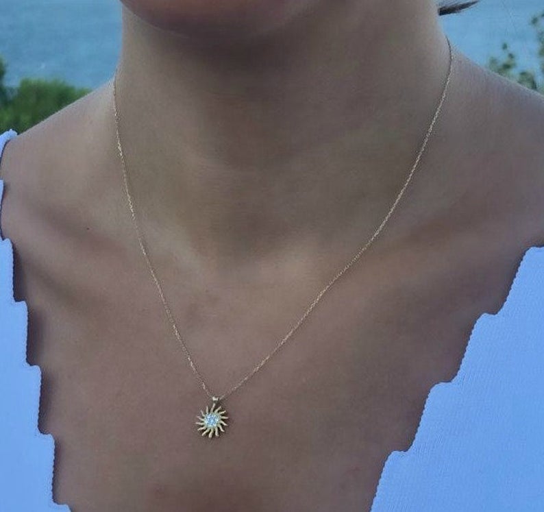 14K solid yellow gold minimalist sun necklace worn on a model, featuring a dainty sun pendant with CZ, perfect for everyday use.