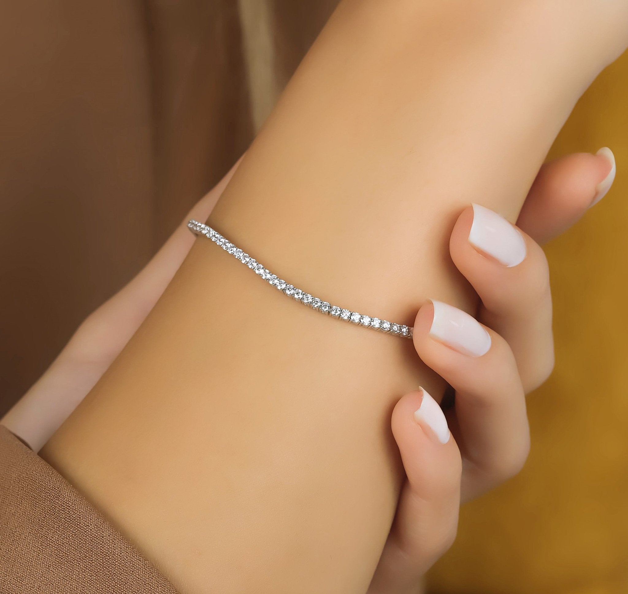 Elegant 14K solid white gold diamond tennis bracelet on a wrist, showcasing sparkling 94 diamonds, 2.40 carats.