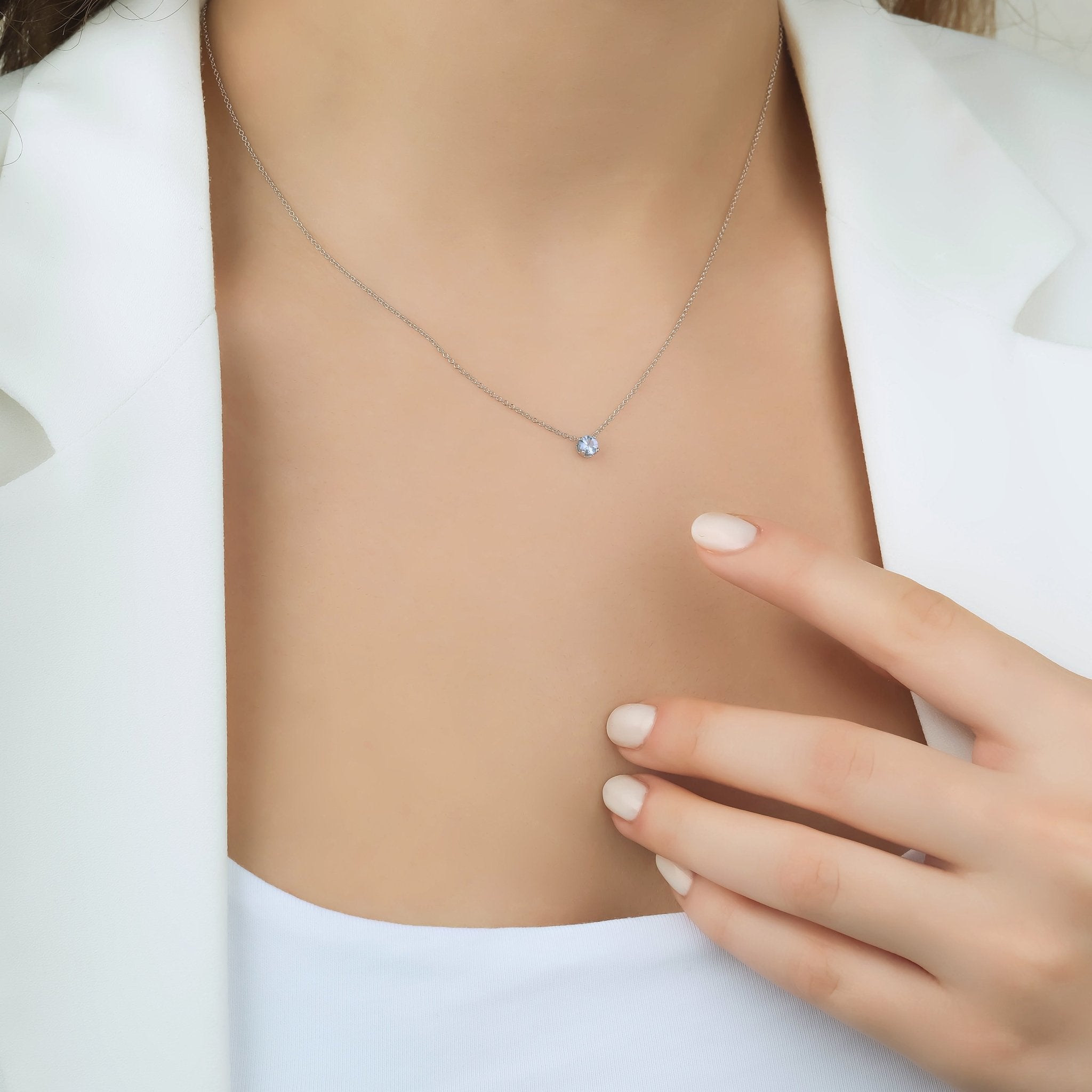14K yellow gold 5mm aquamarine solitaire necklace worn by model, showcasing minimalist elegance and March birthstone.