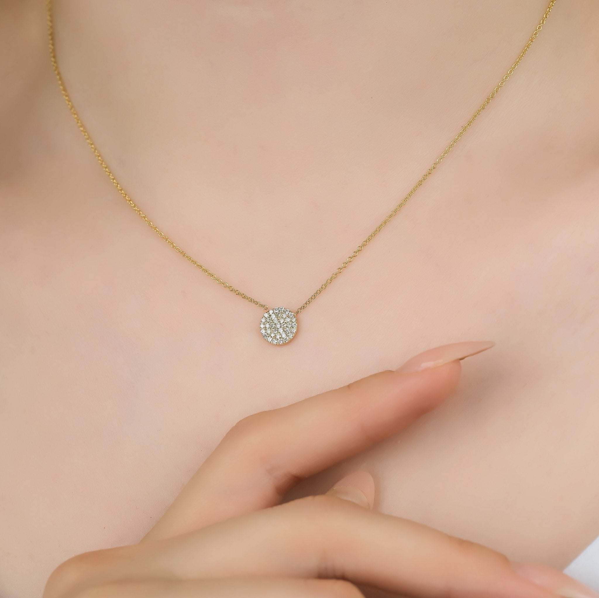 14K solid yellow gold diamond circle necklace on a model, showcasing delicate design and sparkling diamonds.