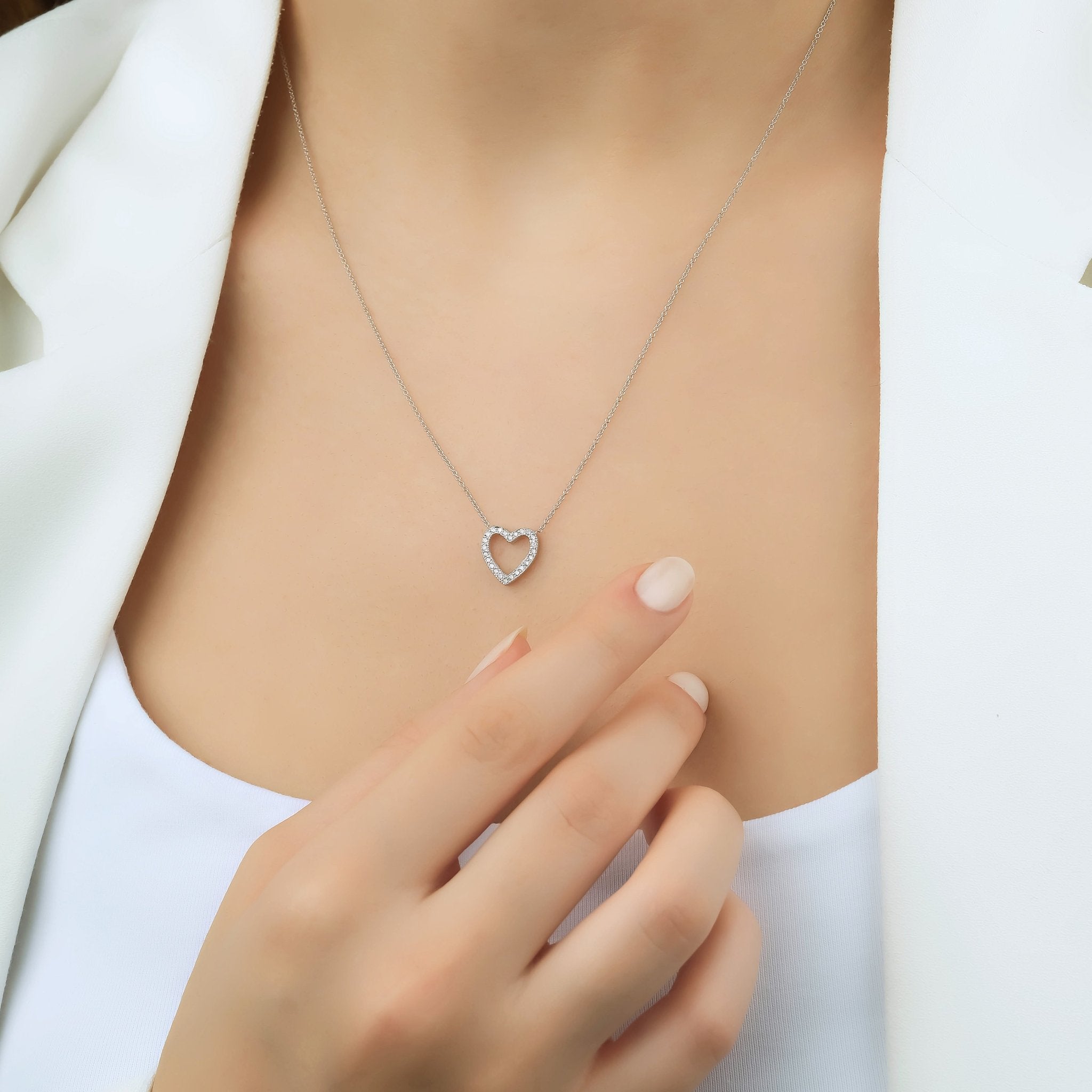 Delicate 14K solid yellow gold diamond heart necklace worn by model, showcasing elegant simplicity.