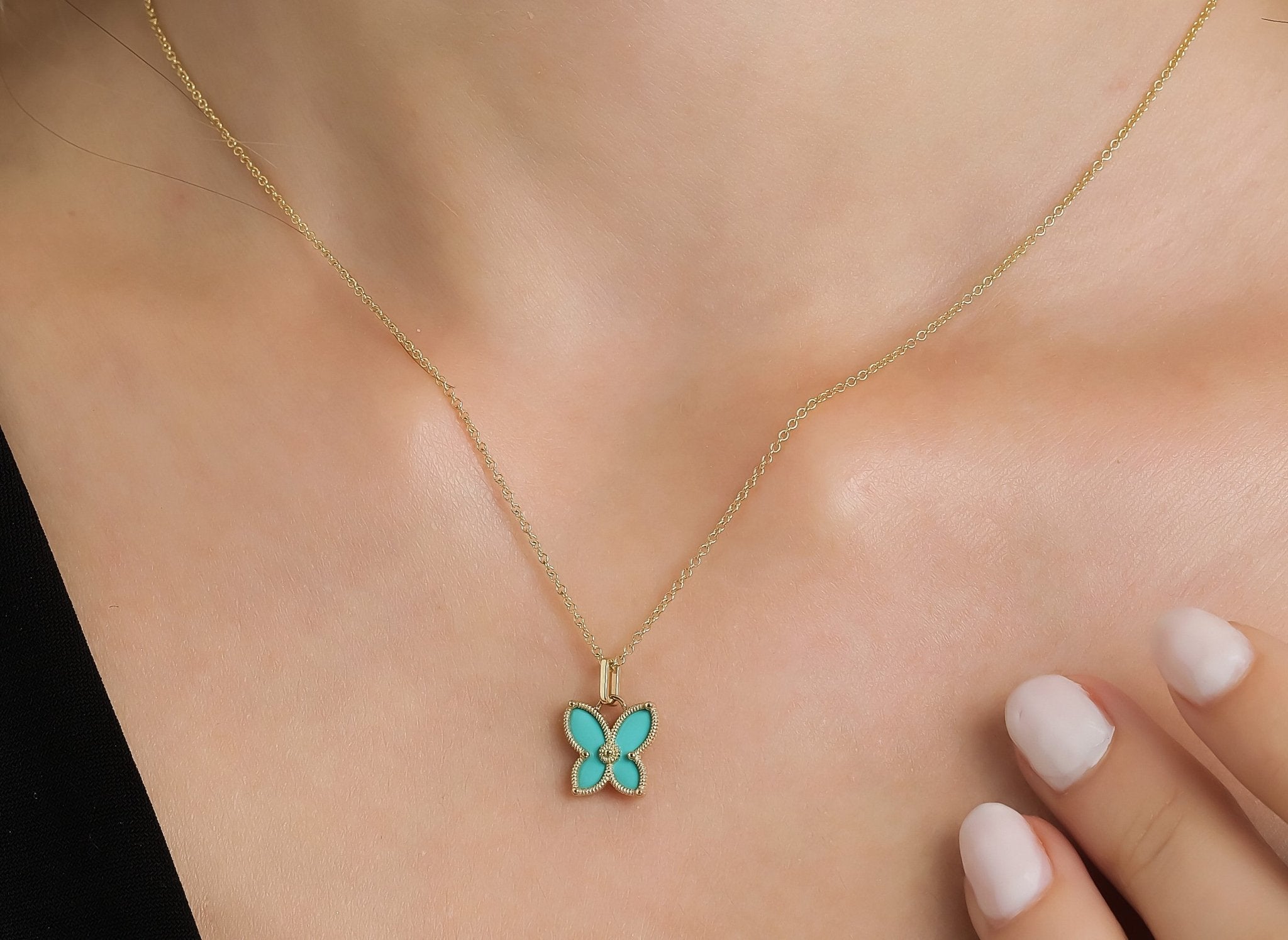 14K yellow gold butterfly pendant necklace with turquoise enamel, perfect for everyday wear, displayed on model.