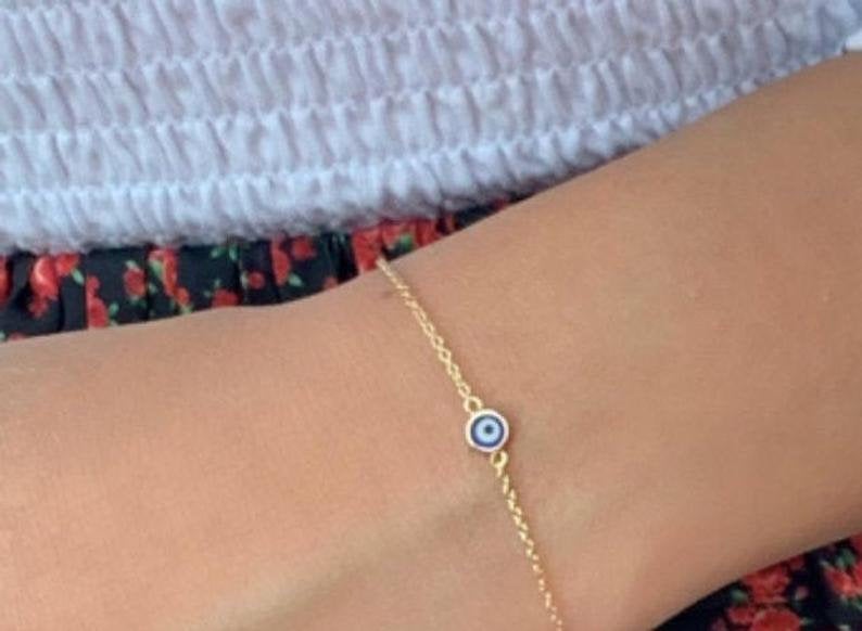 Minimalist 14K solid yellow gold evil eye bracelet, 4.5mm charm on a dainty chain, perfect for everyday wear.