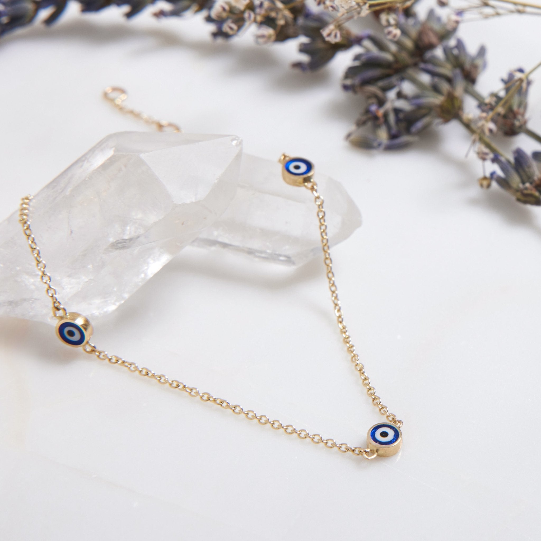 14K solid yellow gold minimalist evil eye bracelet with three evil eye charms, perfect for everyday wear.