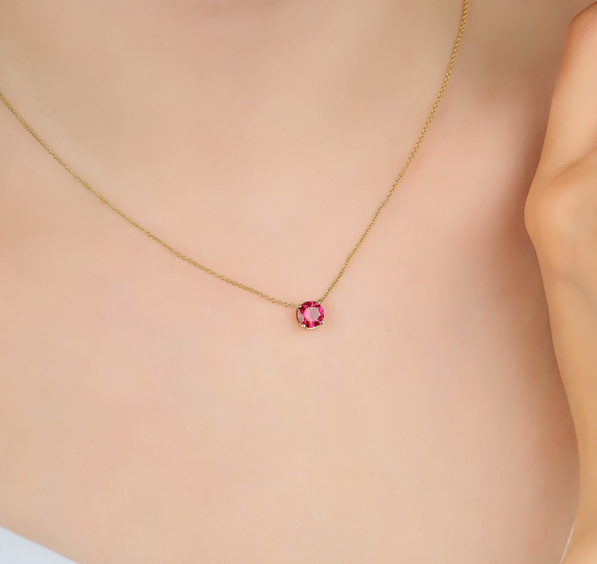 Dainty 14K yellow gold necklace featuring a 6mm prong set lab-created ruby solitaire pendant.