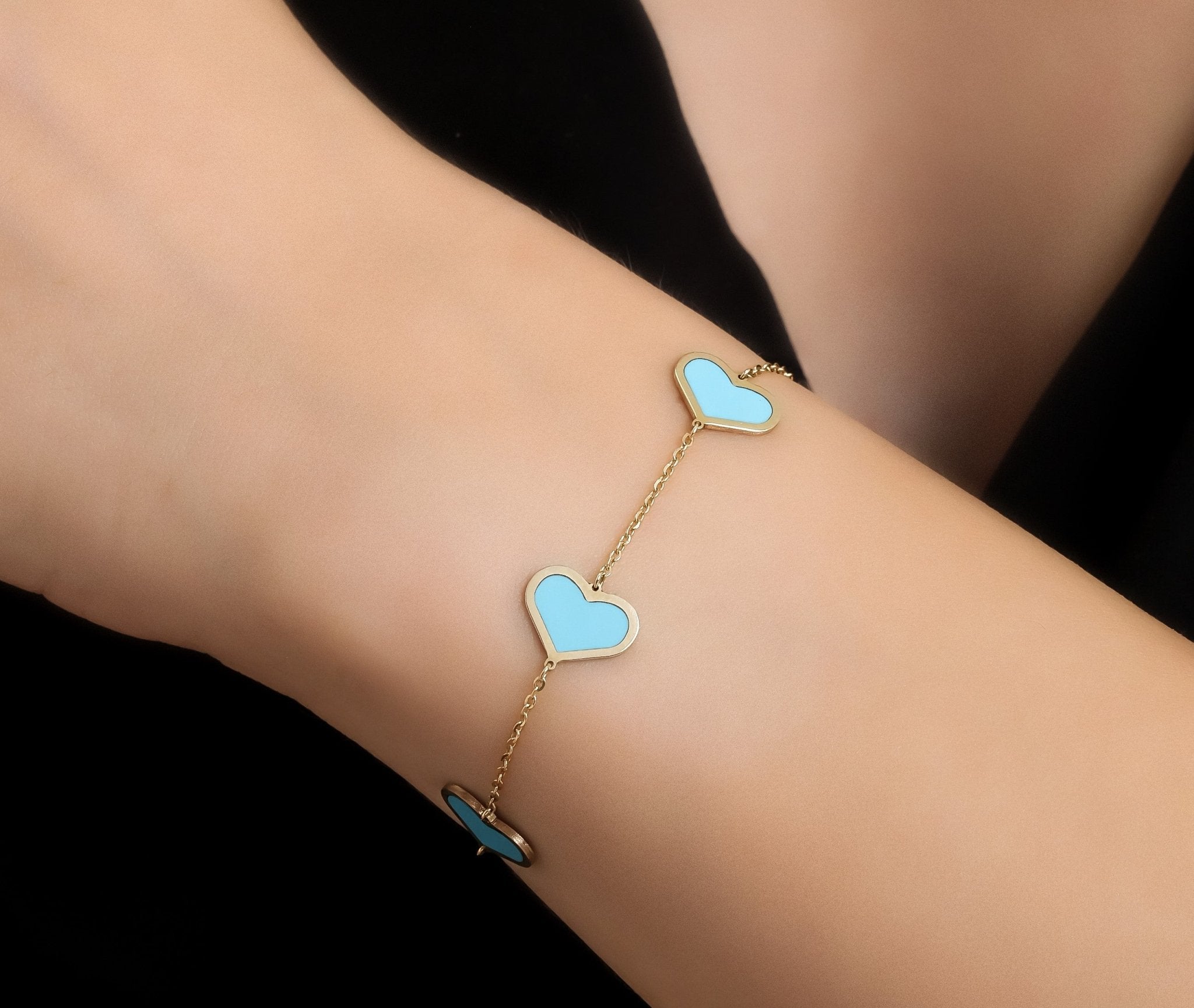 14K solid yellow gold bracelet featuring turquoise heart stations, showcasing elegant design on wrist for stylish accessories.