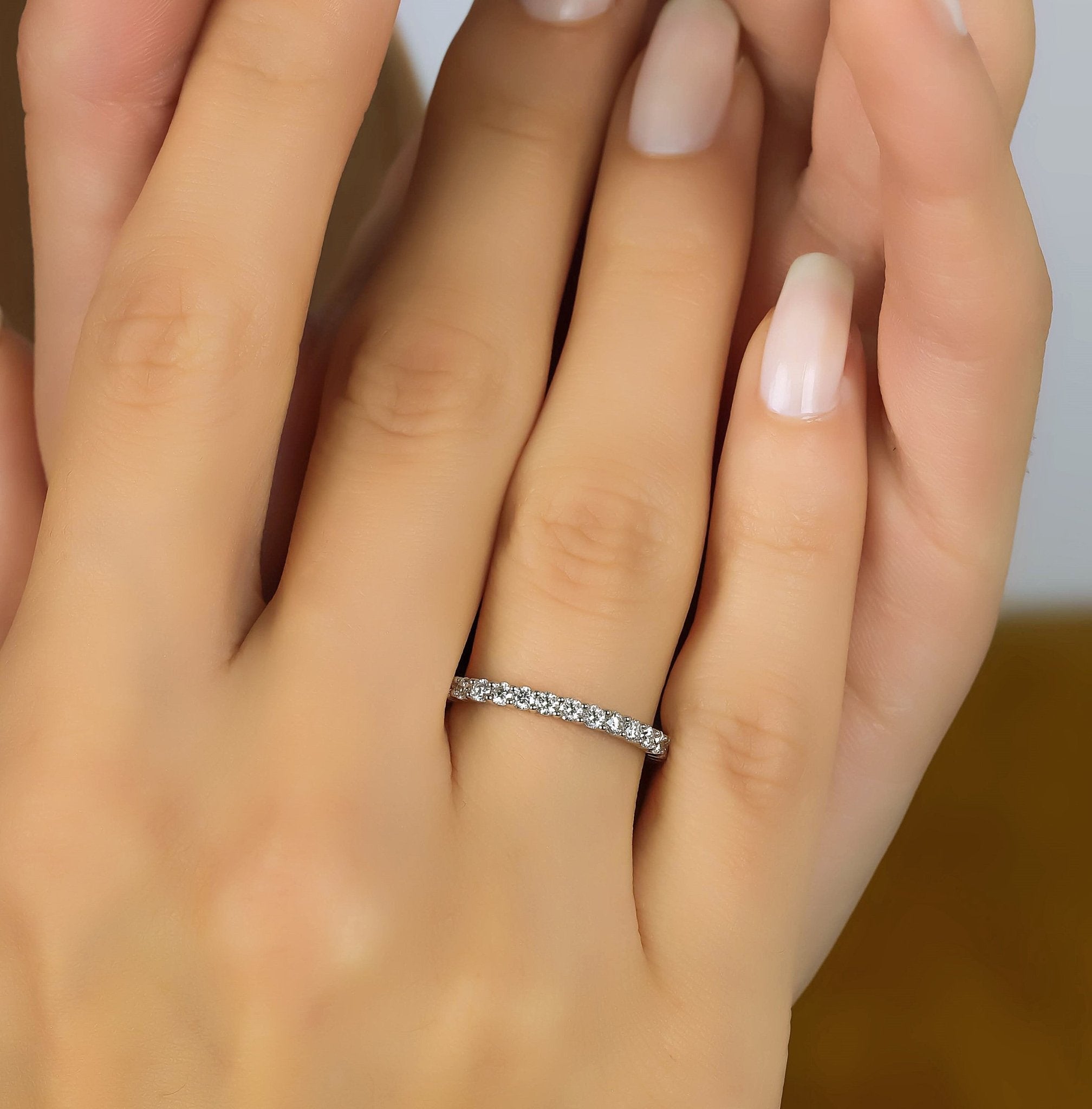 14K white gold diamond eternity wedding ring on a hand, featuring 31 sparkling lab-grown diamonds.