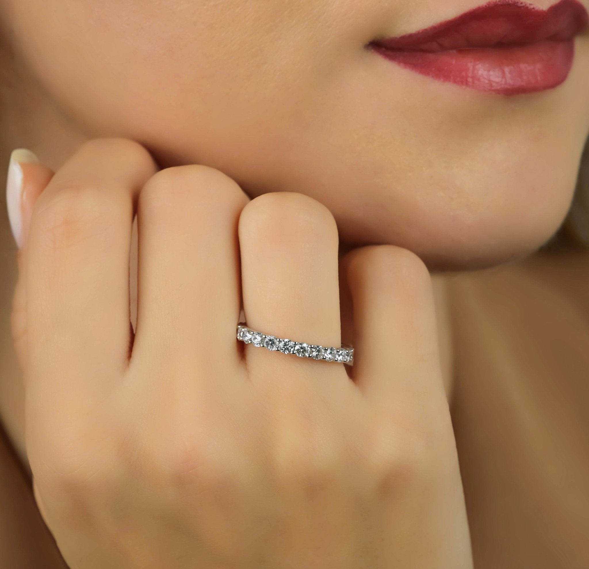 14K white gold diamond wedding band worn on a woman's hand, showcasing 1.65 carats of sparkling round diamonds.