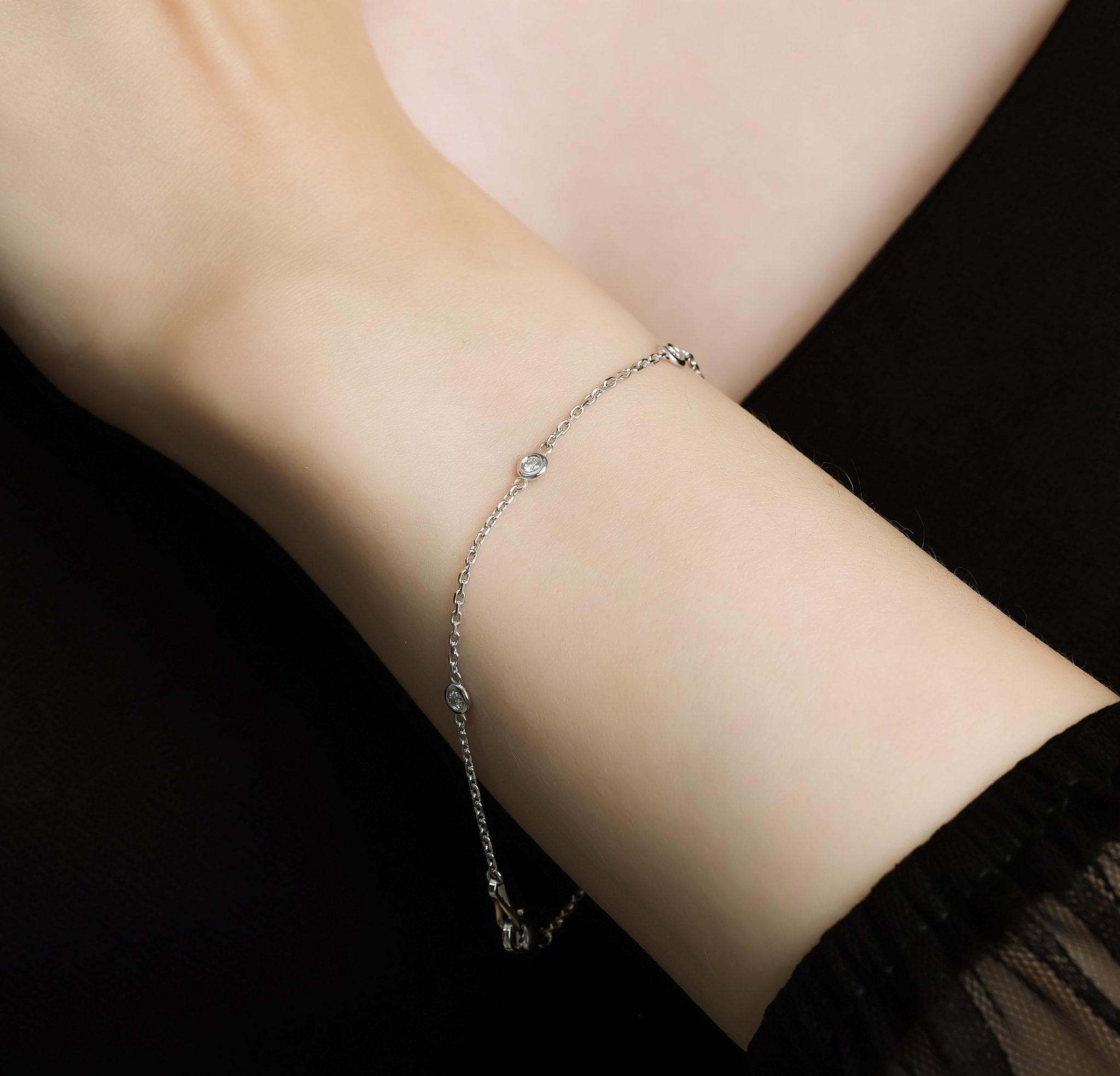 14K white gold diamond by the yard bracelet with five sparkling diamonds on a delicate chain.