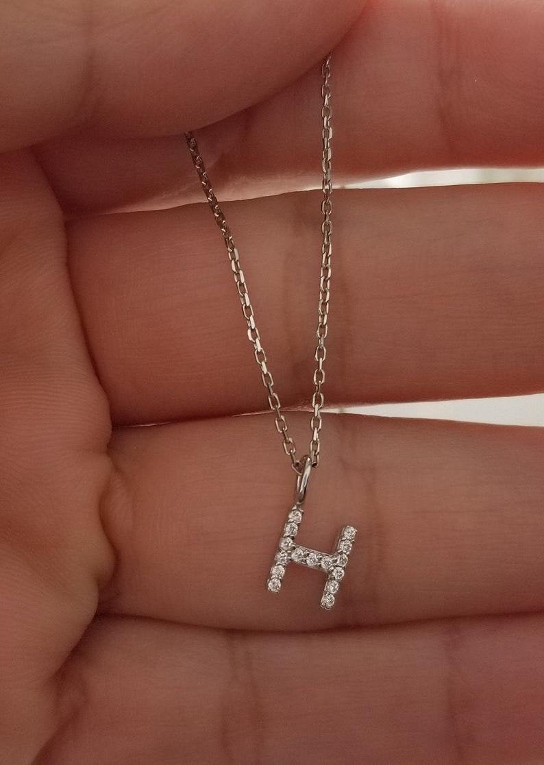 14K white gold diamond initial necklace featuring letter H, dainty design with sparkling diamonds.