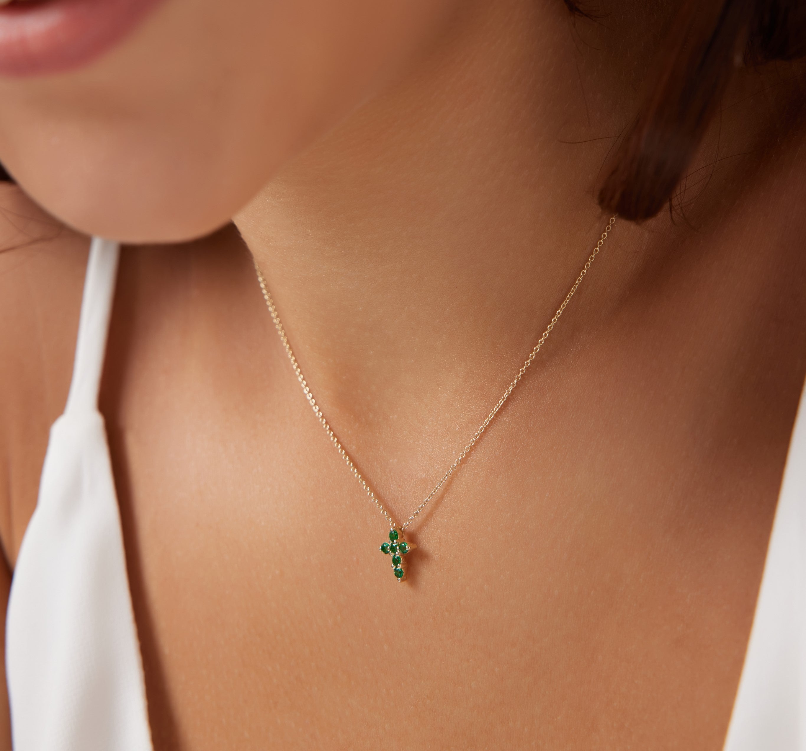 Dainty 14K solid gold necklace with a minimalist emerald cross pendant, perfect for everyday wear.