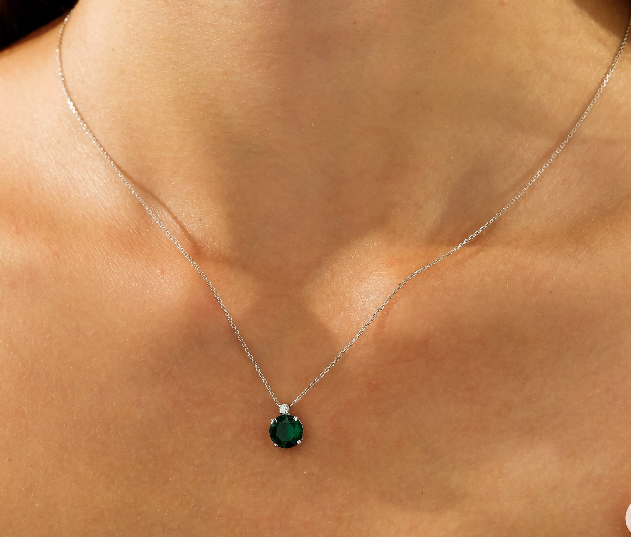 14K white gold emerald solitaire necklace with natural diamond, worn on the neckline, perfect for everyday elegance.