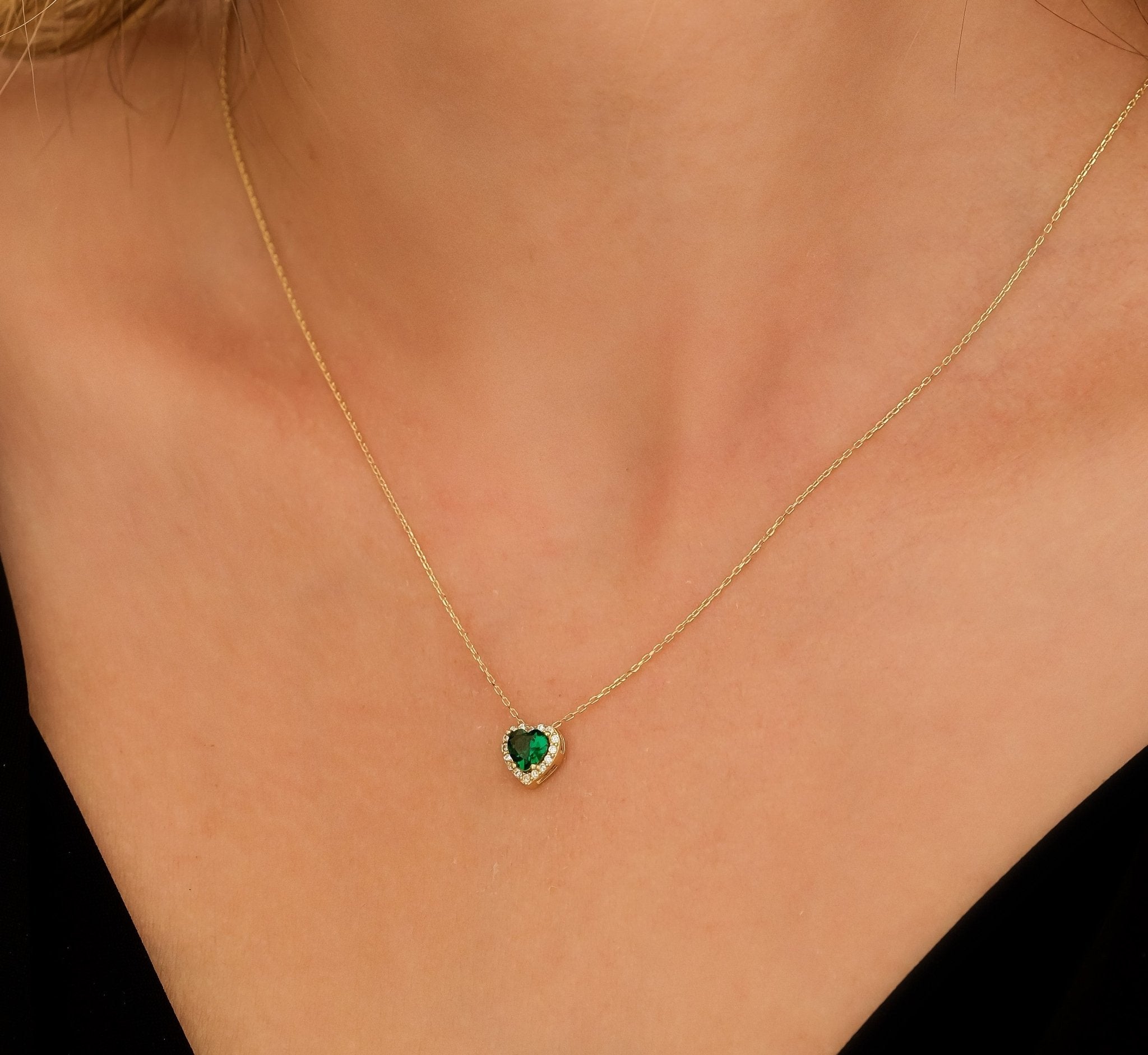14K yellow gold heart shape emerald necklace worn, dainty and minimalist design, perfect for everyday elegance.
