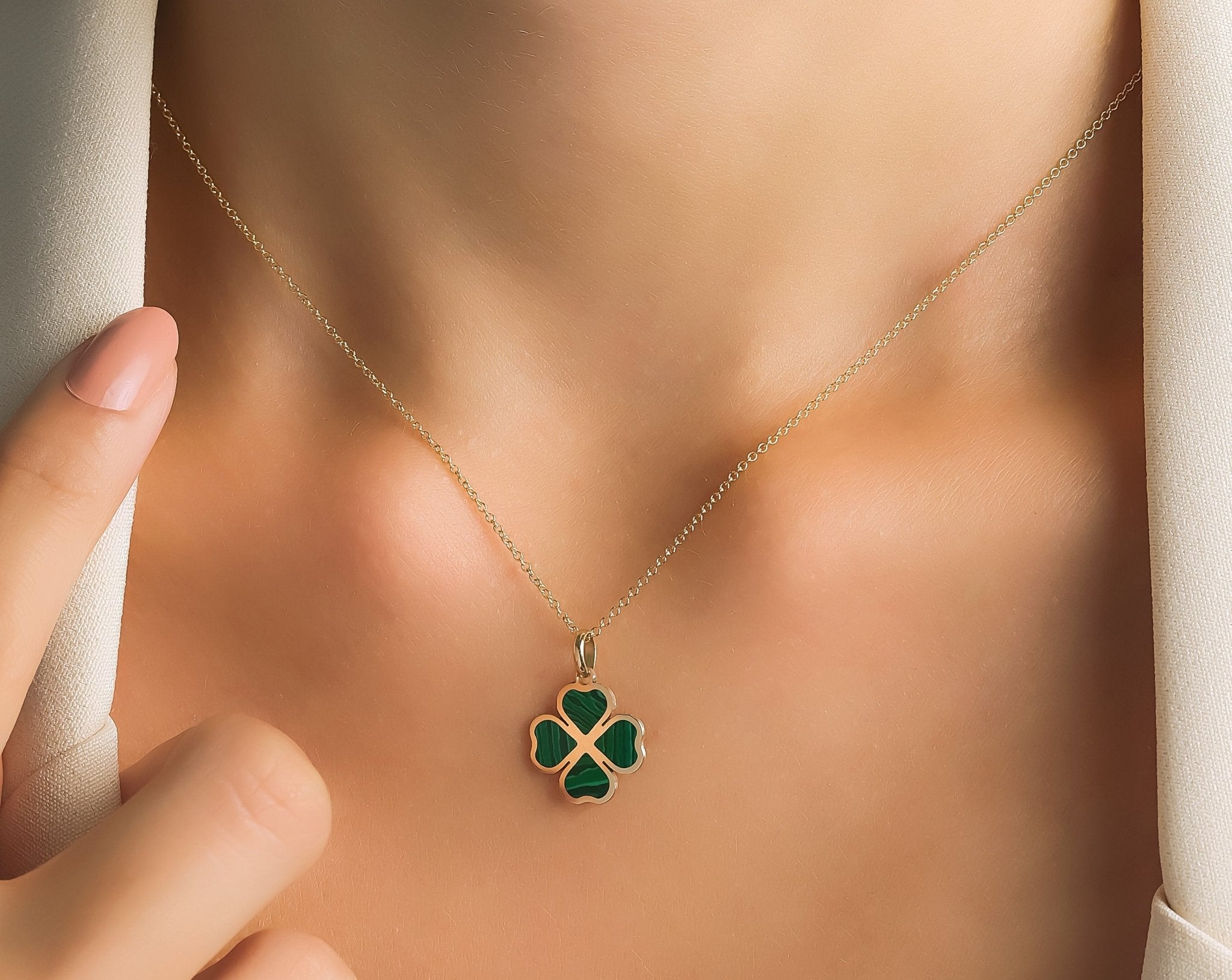 14K yellow gold malachite four leaf clover pendant necklace worn on model, highlighting elegant design and natural beauty.
