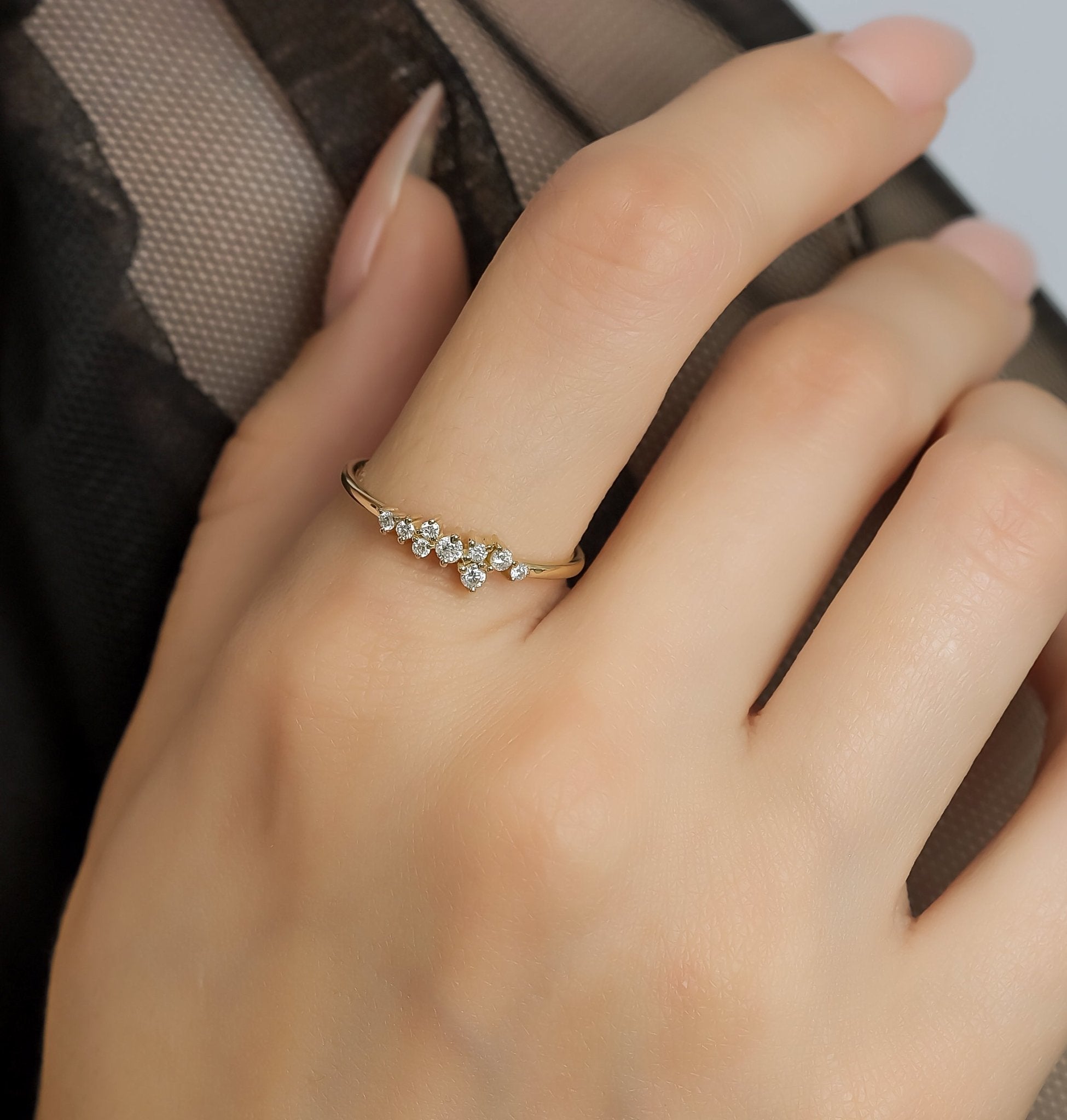 14K yellow gold minimalist diamond cluster ring worn on hand, showcasing delicate design with sparkling round diamonds.