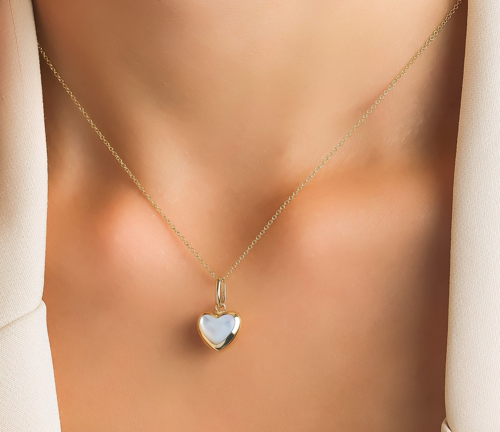 14K yellow gold necklace featuring a natural mother of pearl heart pendant, perfect for everyday elegance.