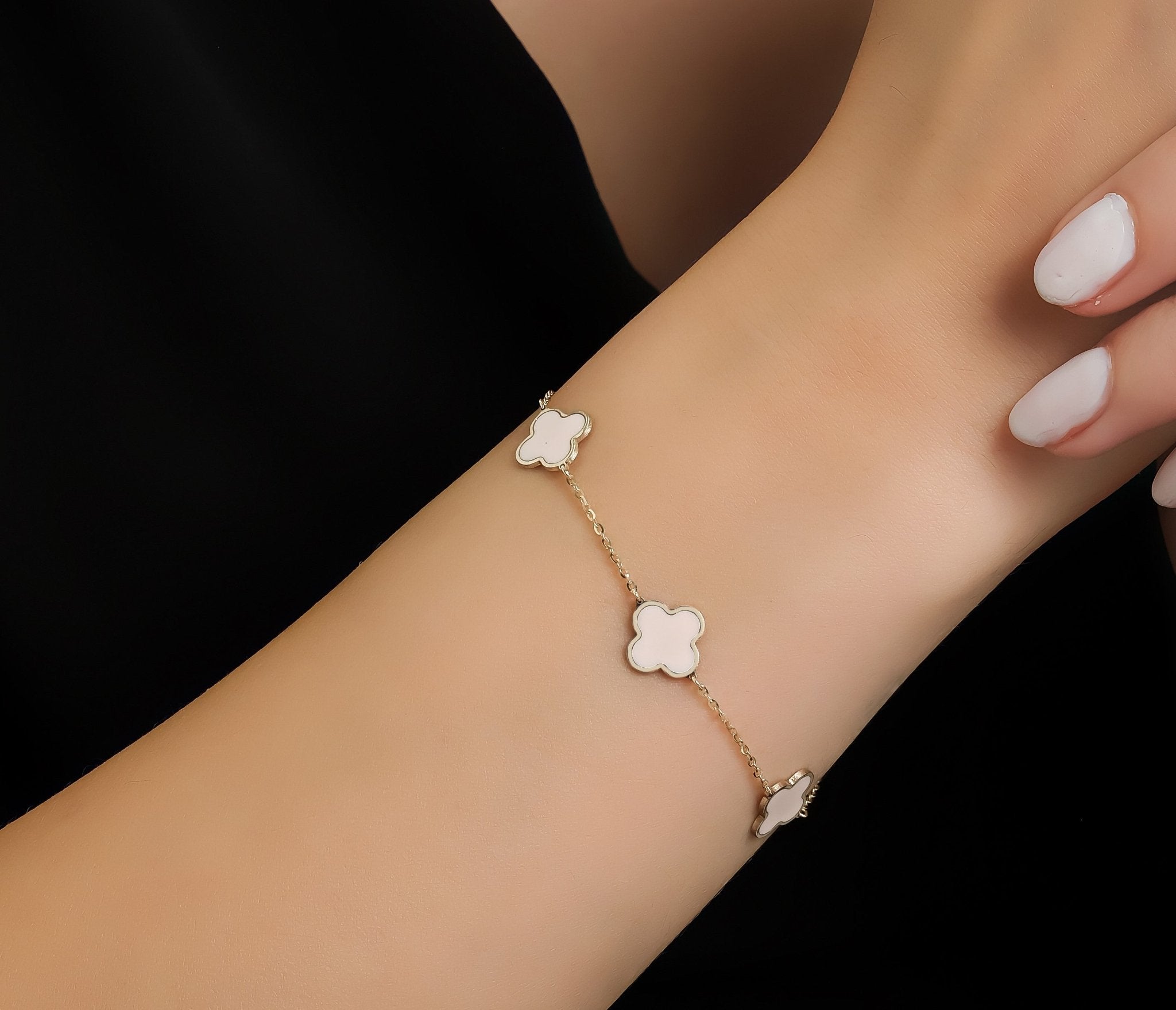 14K Solid Yellow Gold Pink Four Leaf Clover Bracelet worn on wrist, showcasing its elegant design and delicate features.