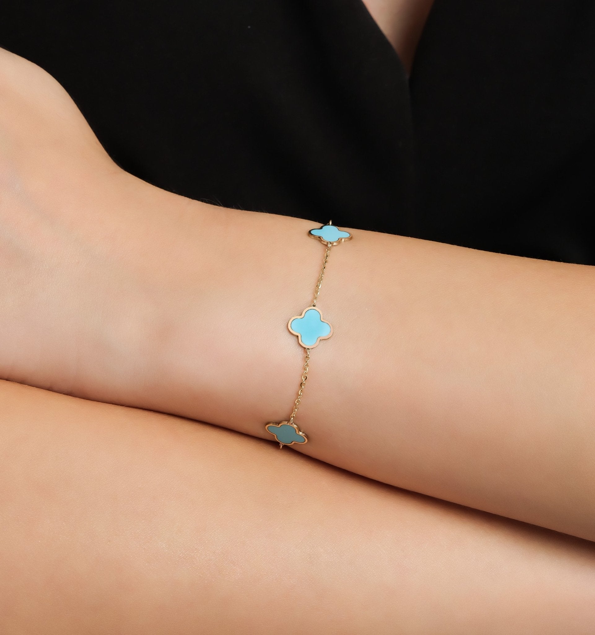 14K solid yellow gold bracelet featuring turquoise four leaf clovers, perfect for gifts. Elegant design worn on a wrist.