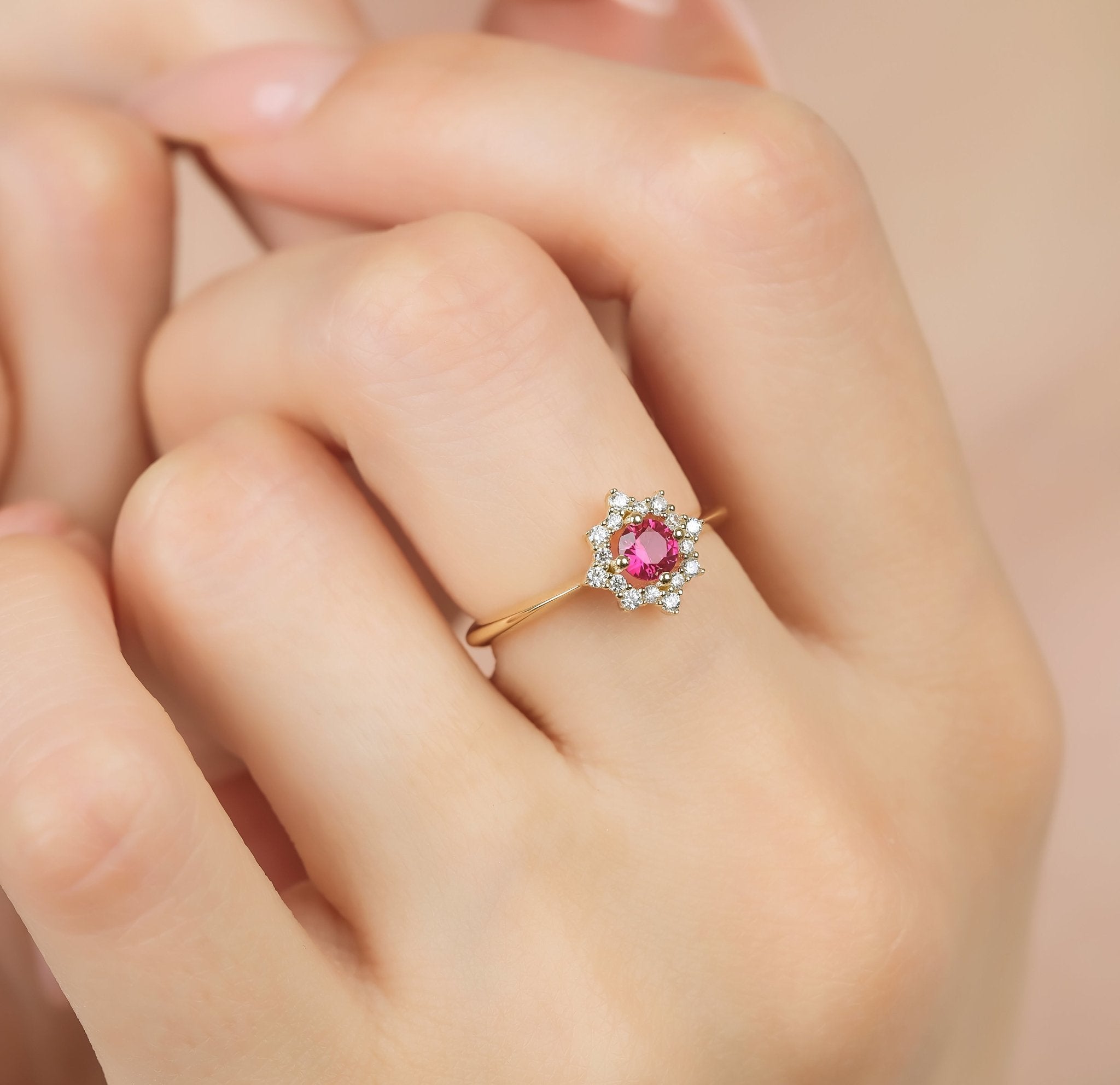 14K yellow gold round ruby ring with CZ, stunning women's wedding ring, displayed on hand.
