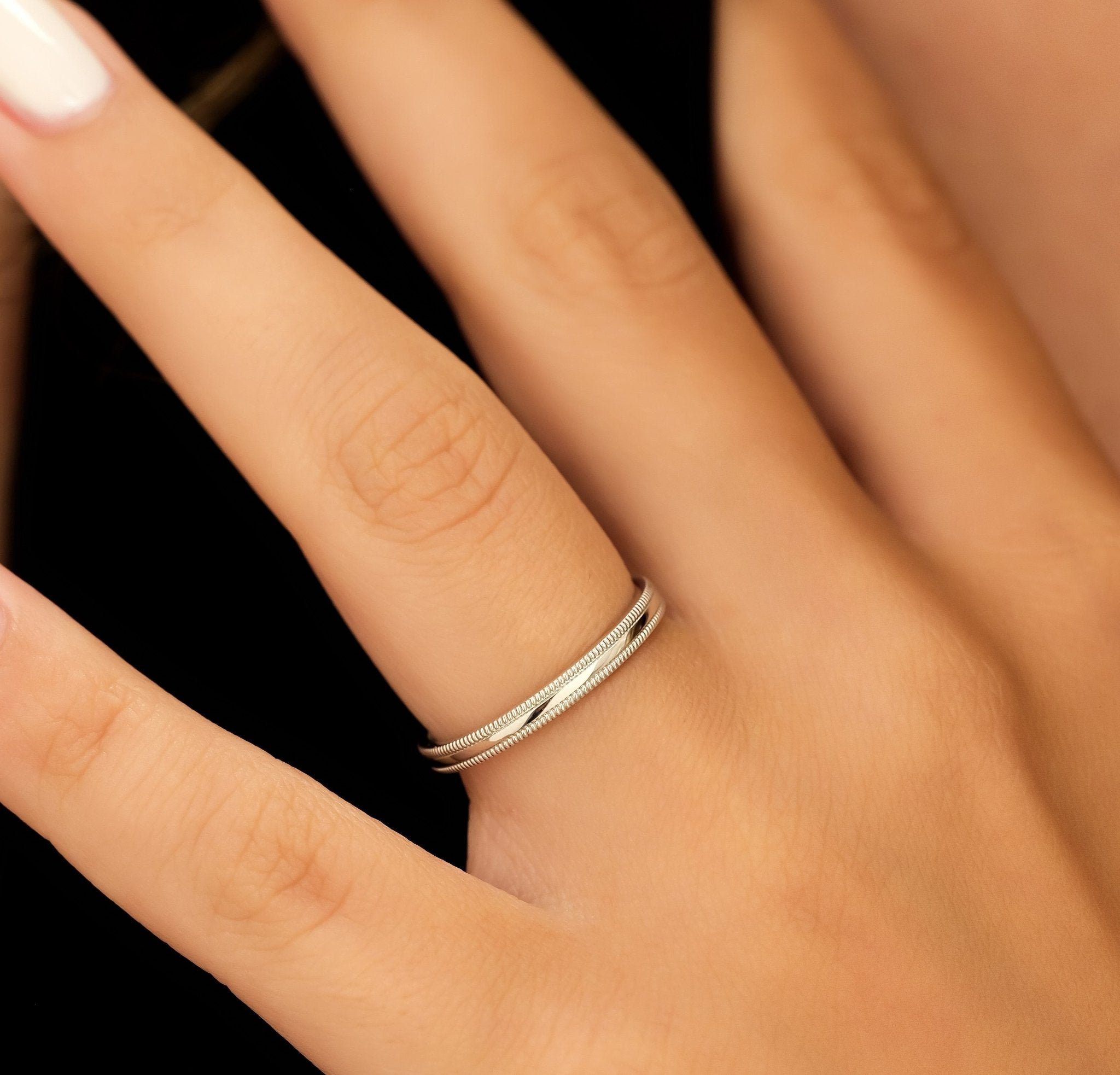 Elegant 3mm dome milgrain platinum wedding band shown on a hand with shiny finish, comfort fitted for men and women.