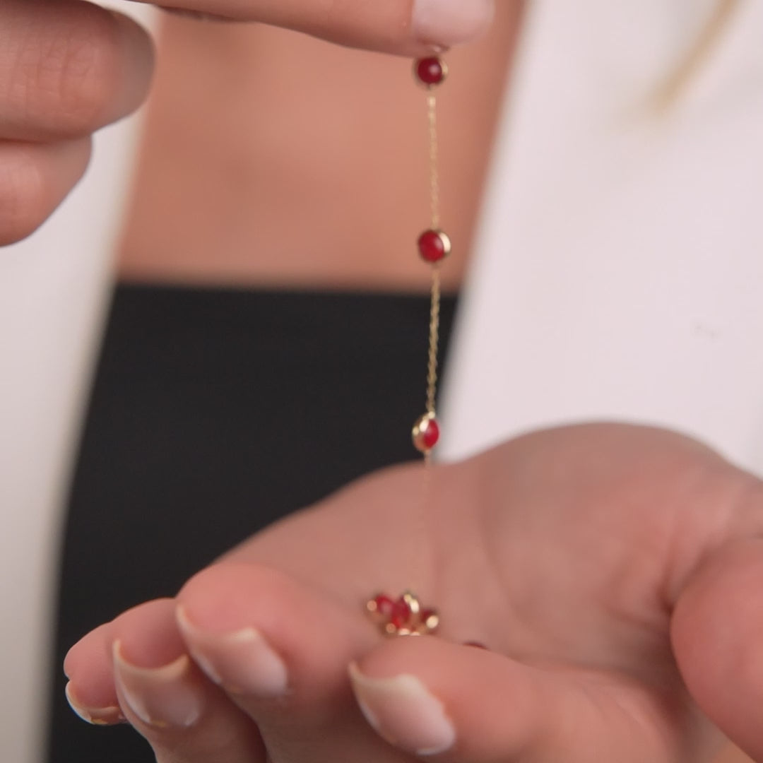 14K solid yellow gold beaded station ruby bracelet shown on hand, featuring delicate ruby stones for a minimalist look.