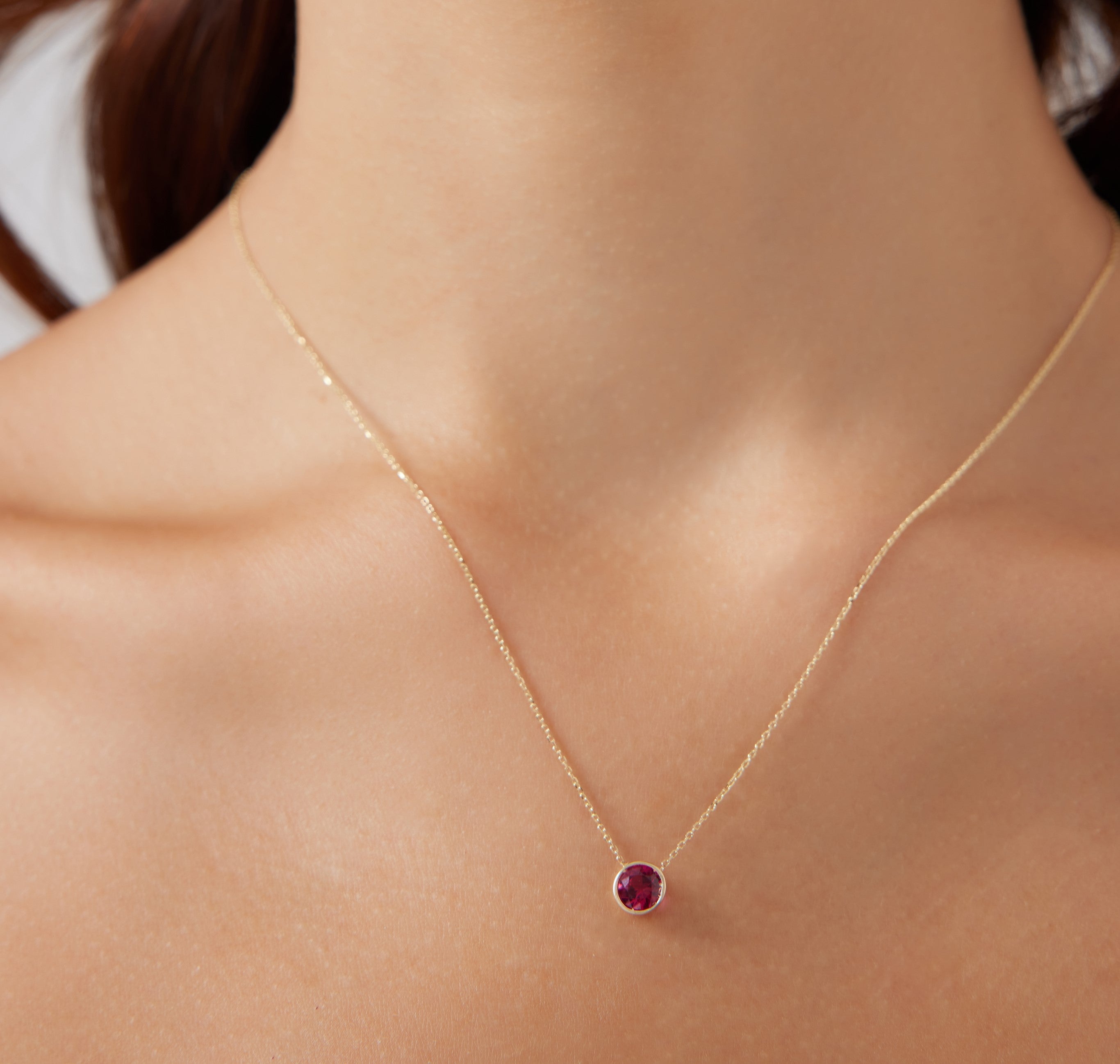 14K yellow gold necklace featuring a 6mm bezel set lab-created ruby solitaire pendant, perfect for everyday wear.