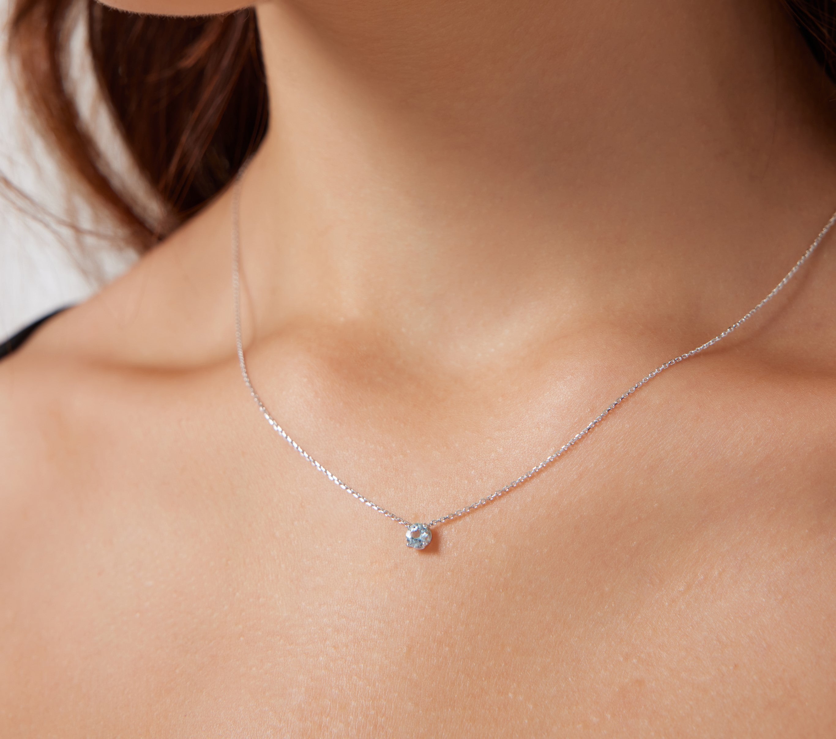 14K white gold 5mm aquamarine solitaire necklace worn on neck, minimalist design perfect for everyday elegance.