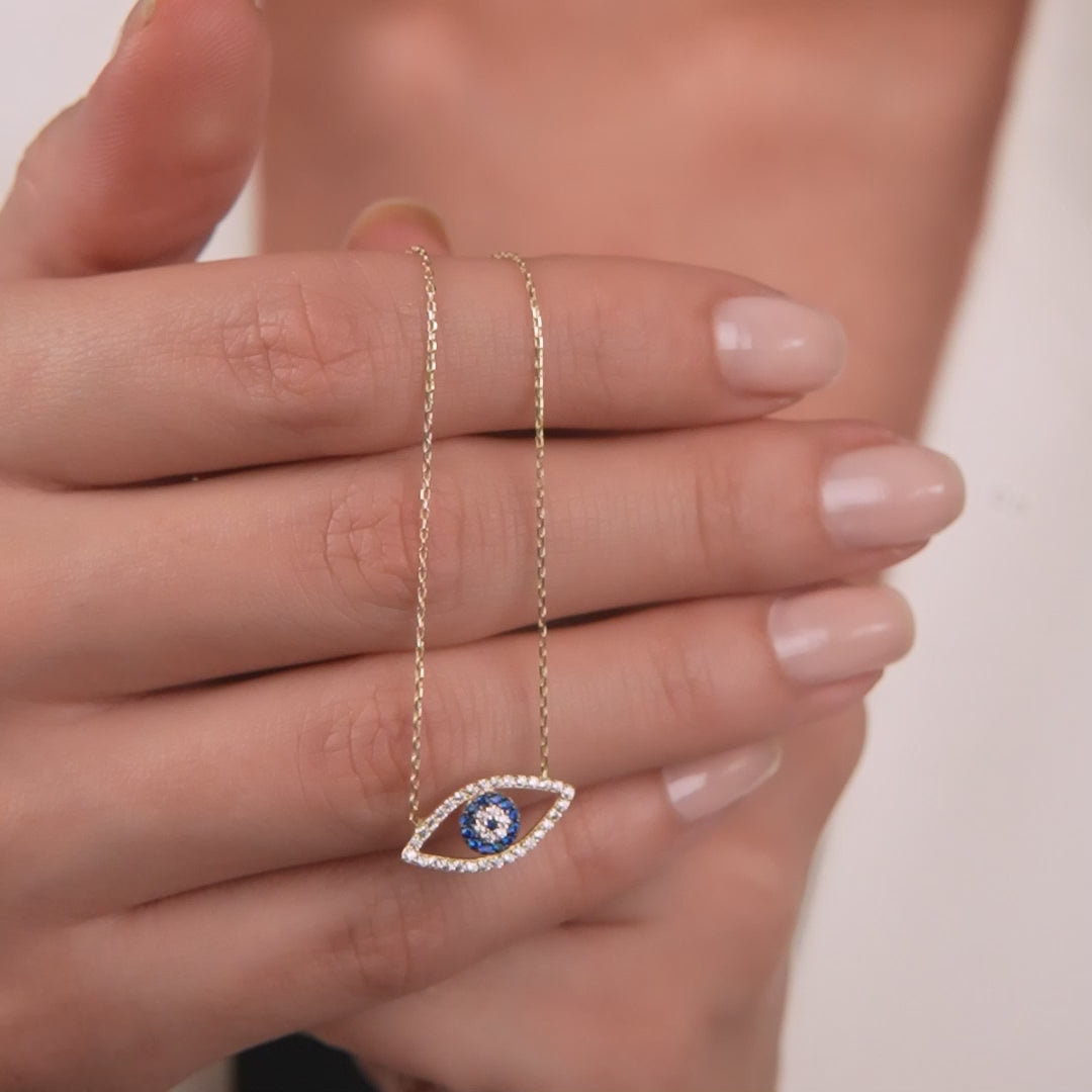 14K solid yellow gold evil eye necklace worn by a model, featuring a sparkling blue center and delicate chain.