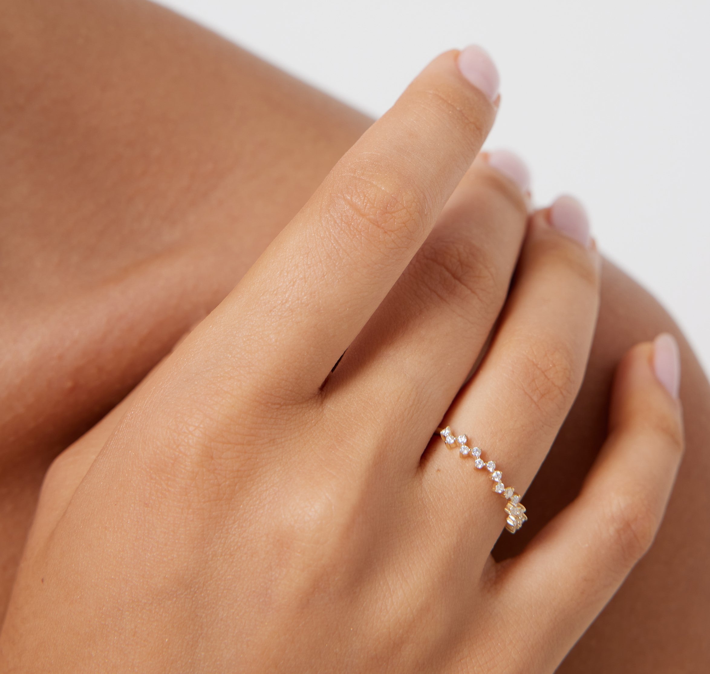 14K yellow gold minimalist diamond cluster ring worn on a hand, showcasing delicate design and sparkling diamonds.
