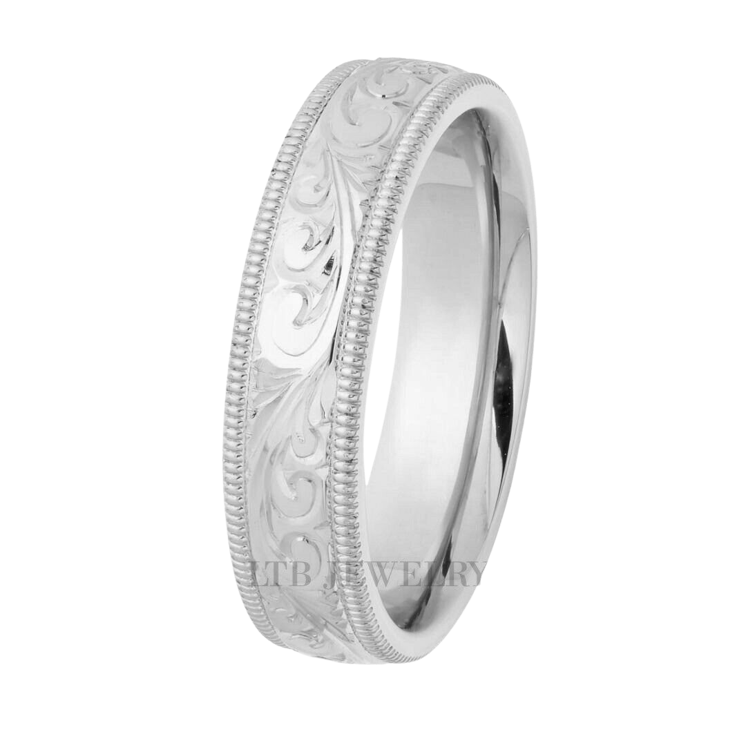 Hand engraved platinum wedding band with leaf motifs and milgrain details, comfort fit design.