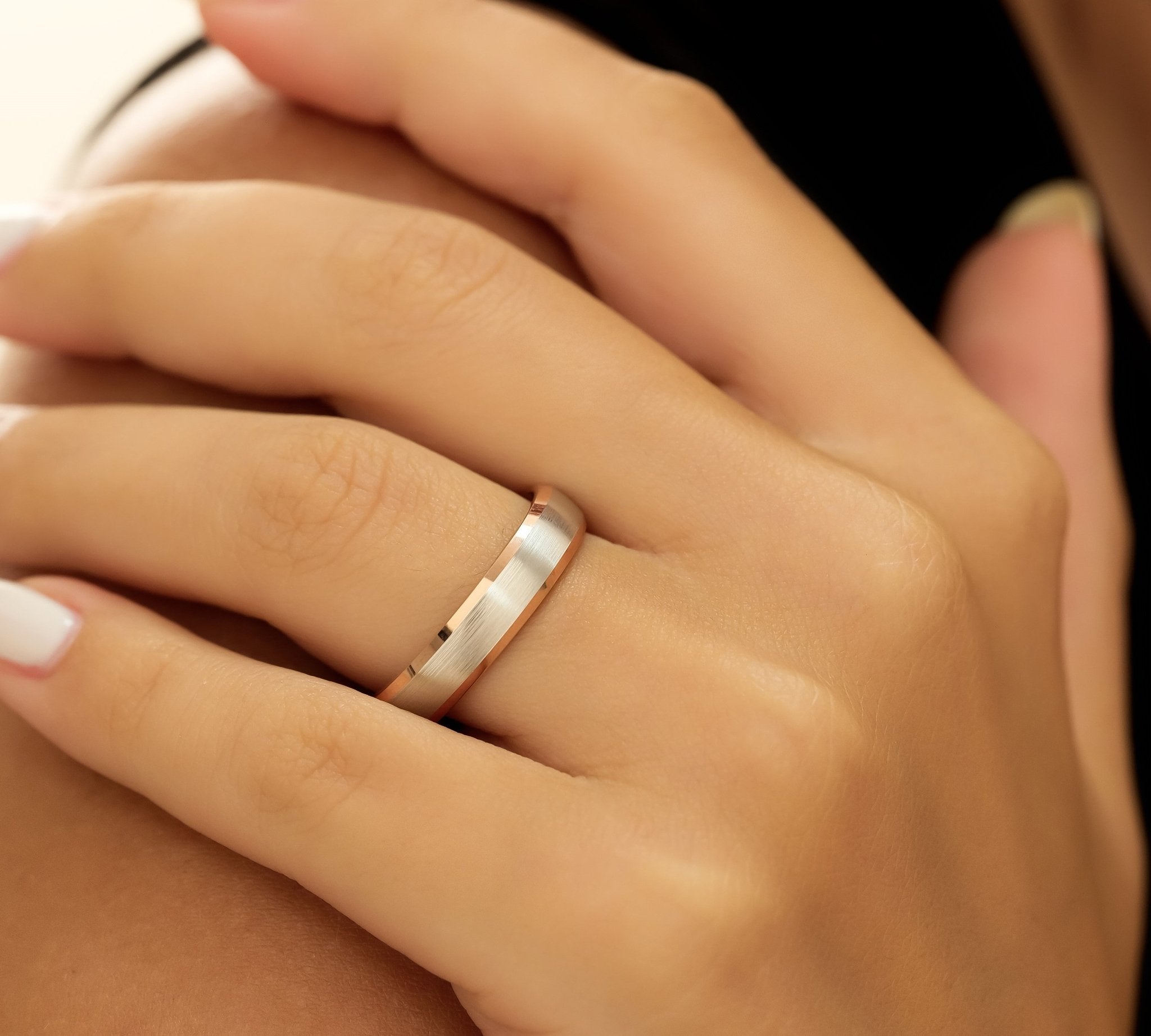 Stylish two-tone gold wedding band featuring a satin-finished white gold center and shiny rose gold edges, comfort fitted.